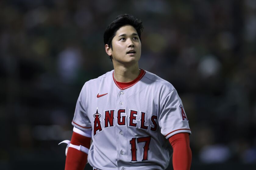 Los Angeles Angels' Shohei Ohtani walks back to the dugout after striking out against the Oakland Athletics during the sixth inning of an opening day baseball game in Oakland, Calif., Thursday, March 30, 2023. (AP Photo/Jed Jacobsohn)