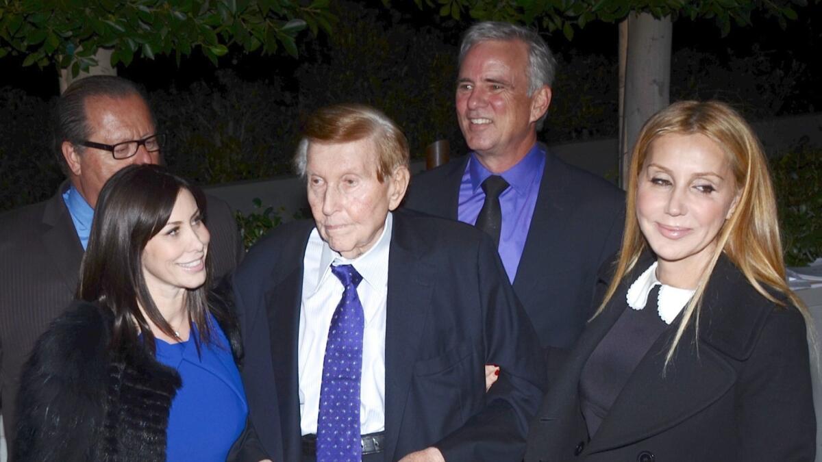 Sumner Redstone with his now-former companions, Sydney Holland, left, and Manuela Herzer, in 2013.