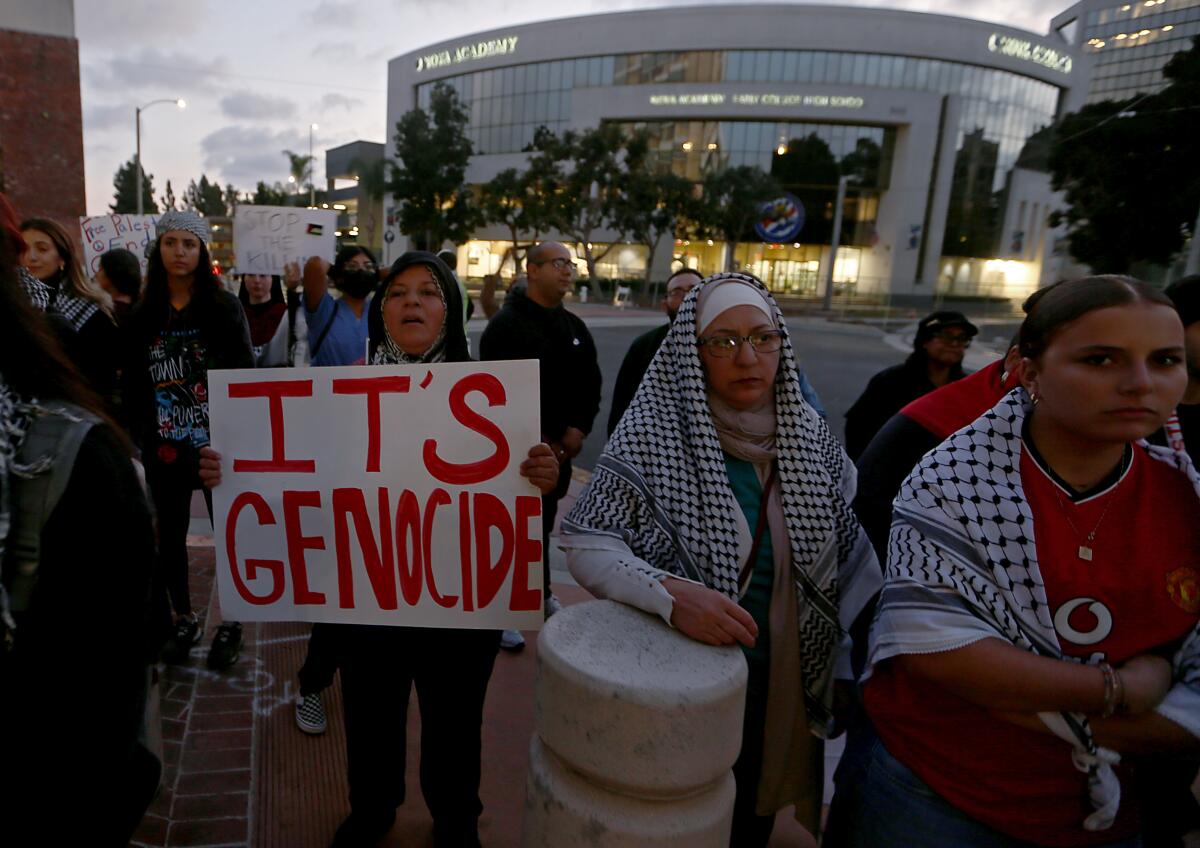 People show support for the Palestinians under siege in the Gaza Strip during a rally in Santa Ana on Oct. 25. 