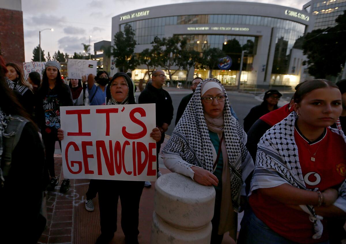 People show support for the Palestinians under siege in the Gaza Strip during a rally in Santa Ana on Oct. 25.