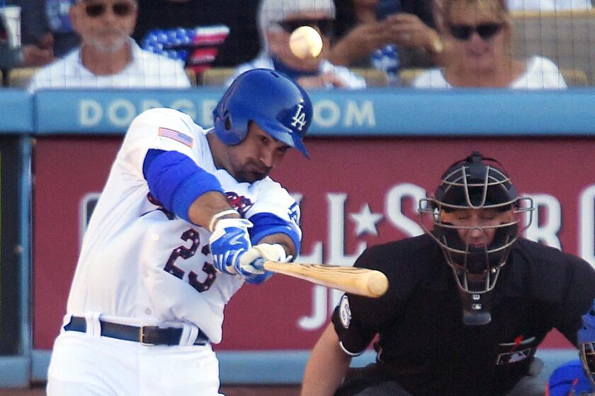 Dodgers first baseman Adrian Gonzalez hits a solo home run against Mets starter Matt Harvey on Saturday.