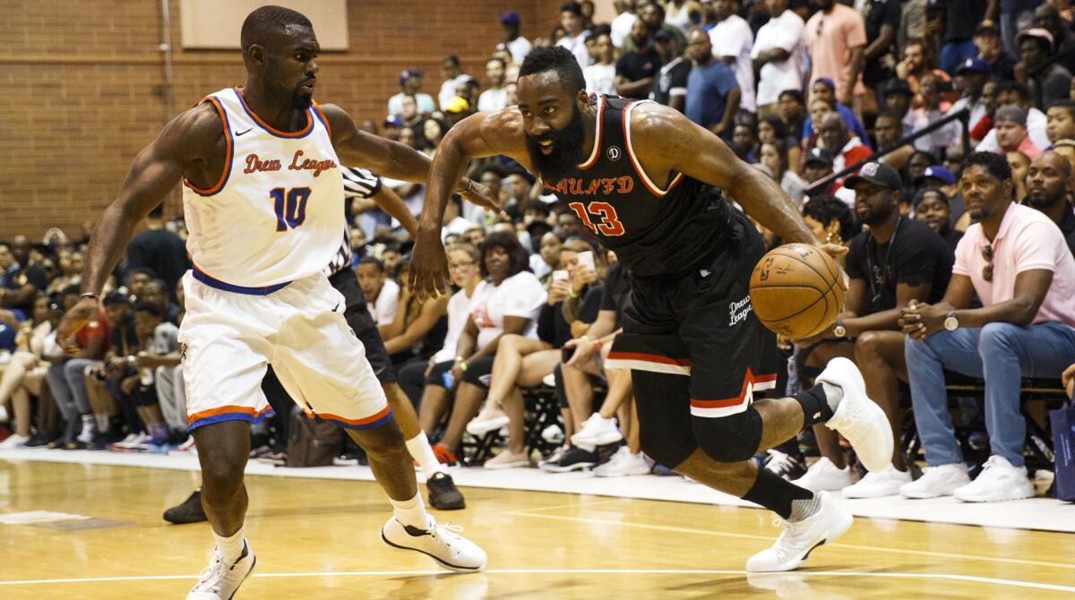 Rockets' James Harden, right, and Hawks' Tim Hardaway Jr. play the Drew League in 2017.