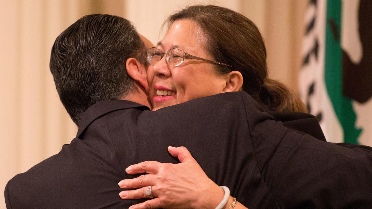 State Controller Betty Yee greets a lawmaker during a joint session of the California Legislature in 2016. (Brian van der Brug / Los Angeles Times)