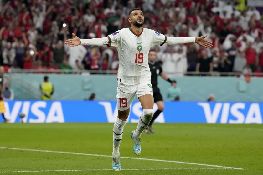 Morocco's Youssef En-Nesyri celebrates after he scored his side's second goal during the World Cup group F soccer match between Canada and Morocco at the Al Thumama Stadium in Doha , Qatar, Thursday, Dec. 1, 2022. (AP Photo/Natacha Pisarenko)