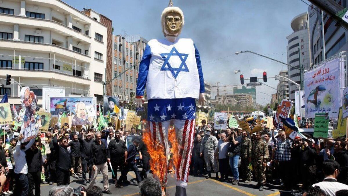 Iranian protesters burn an effigy of President Trump dressed in an Israeli flag during a rally to mark "Jerusalem Day," an annual demonstration against Israel begun in 1979.