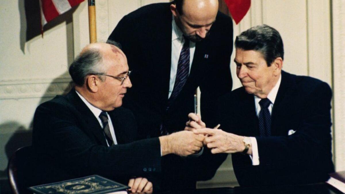 President Reagan and Soviet leader Mikhail S. Gorbachev exchange pens during the signing of the Intermediate Range Nuclear Forces Treaty at the White House on Dec. 8, 1987.