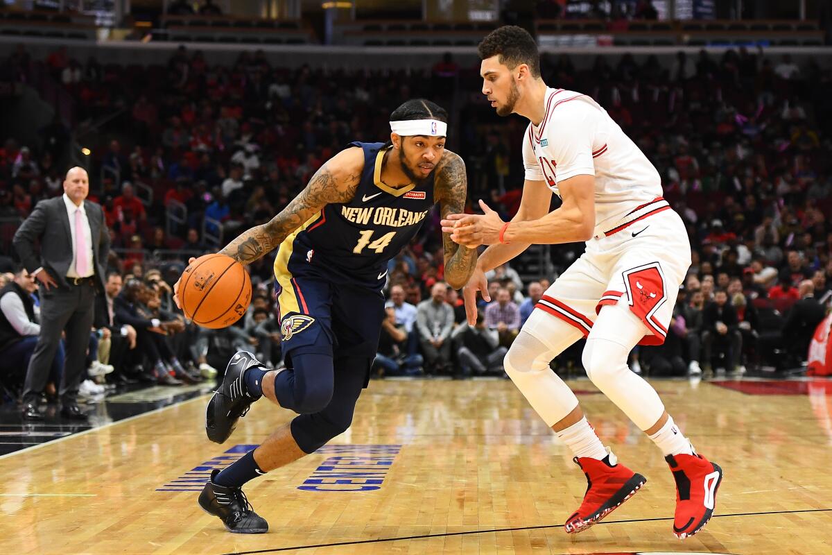 Pelicans forward Brandon Ingram drives against Bulls guard Zach LaVine during a preseason game Oct. 9, 2019.