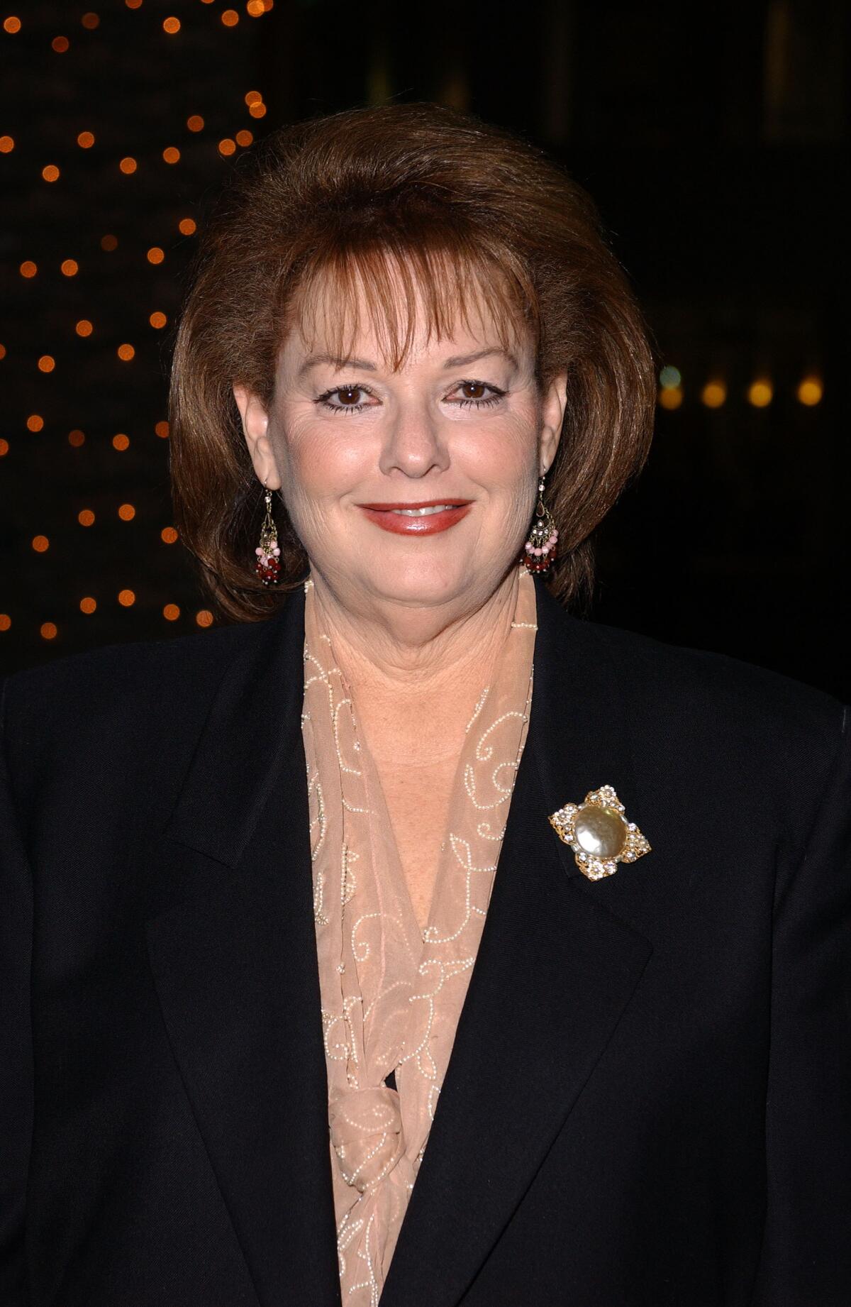 Deborah Joy Levine in a dark blazer posing for a photo.