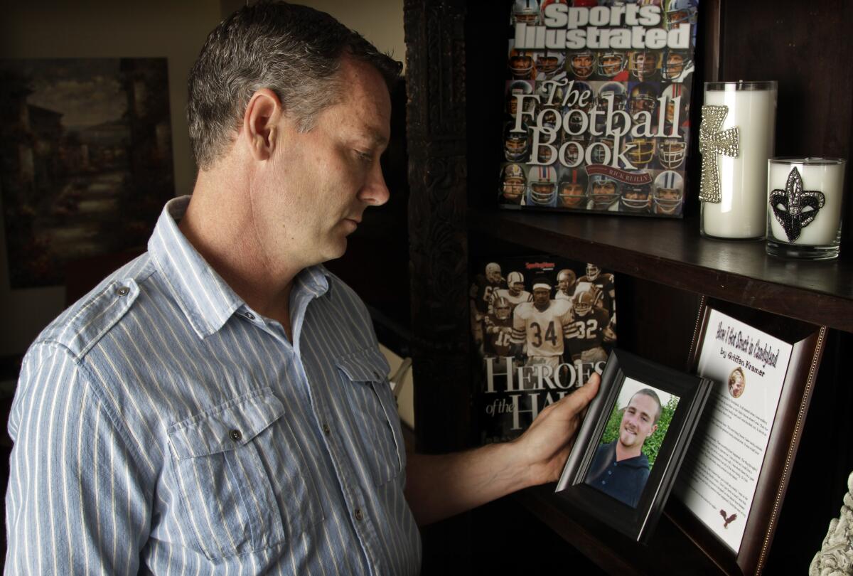 Erik Kramer, holding a picture of his son Griffen, at his home in Agoura Hills in April 2012.