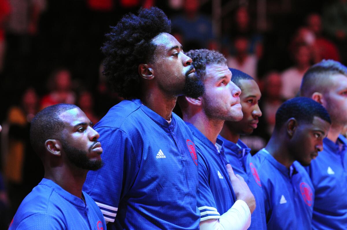 Chris Paul, DeAndre Jordan and Blake Griffin listen to the National Anthem before a game at Staples Center on Oct. 20.