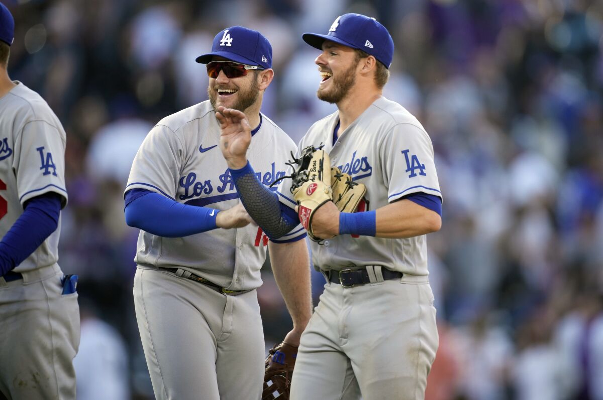 Second baseman Gavin Lux, right, and third baseman Max Muncy celebrate the Dodgers' win April 8, 2022.