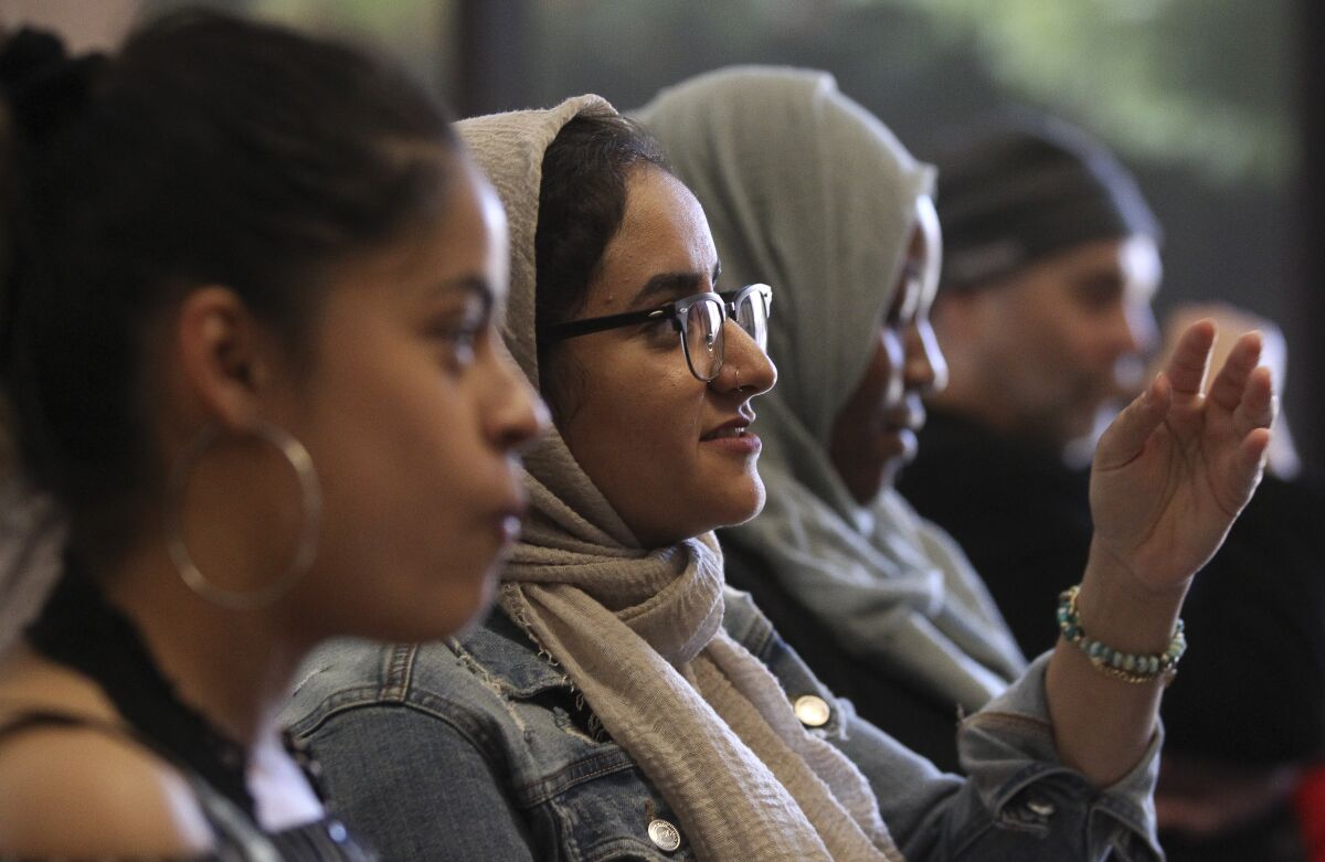 Sarah Farouq, 20, a UC Berkeley student, reacts as she and other young adults watch the Democratic presidential debate during a watch party, put on by Youth Will, at the Jacobs Center For Neighborhood Innovation on Wednesday, June 26, 2019 in San Diego, California.