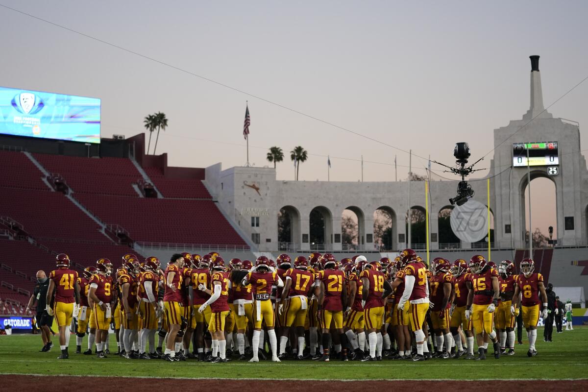 USC players gather on the field as they finish warming up before playing Oregon in the Pac-12 championship game 