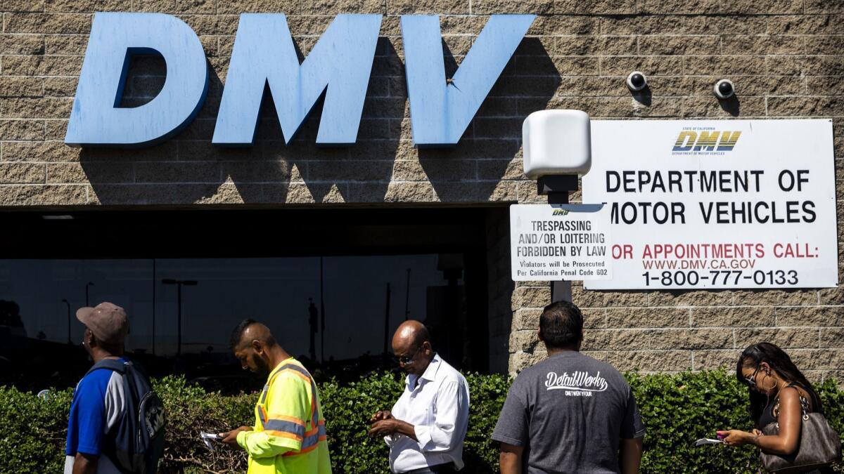 A line of people waiting to be helped at a California Department of Motor Vehicles office in South L.A. stretches around the building.