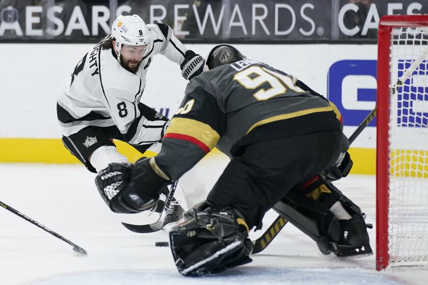 Los Angeles Kings defenseman Drew Doughty (8) attempts a shot on Vegas Golden Knights goaltender Robin Lehner (90) during the third period of an NHL hockey game Monday, March 29, 2021, in Las Vegas. (AP Photo/John Locher)