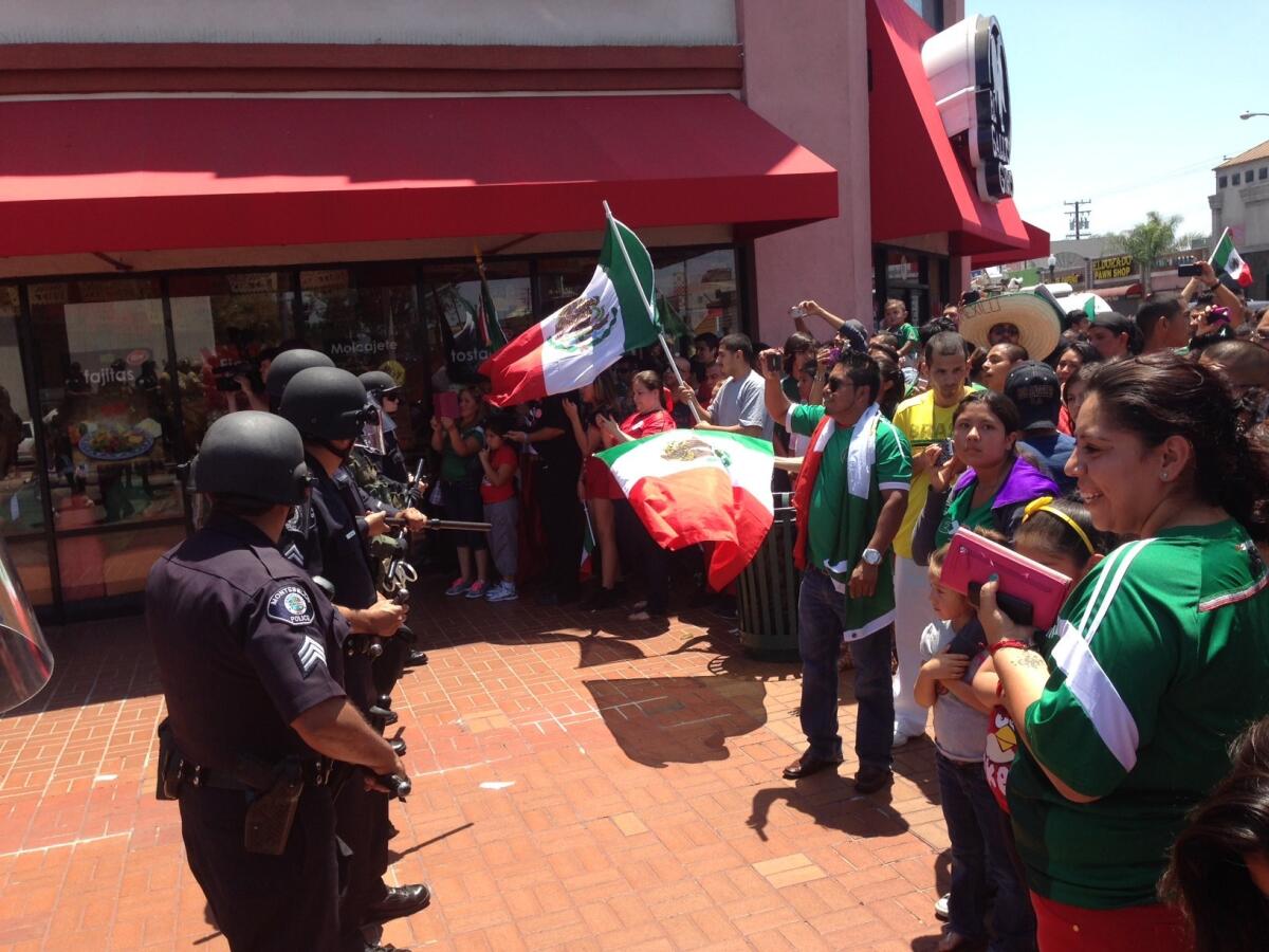 Huntington Park police in riot gear face off with crowd after Mexico's loss to the Netherlands in their World Cup match Sunday.