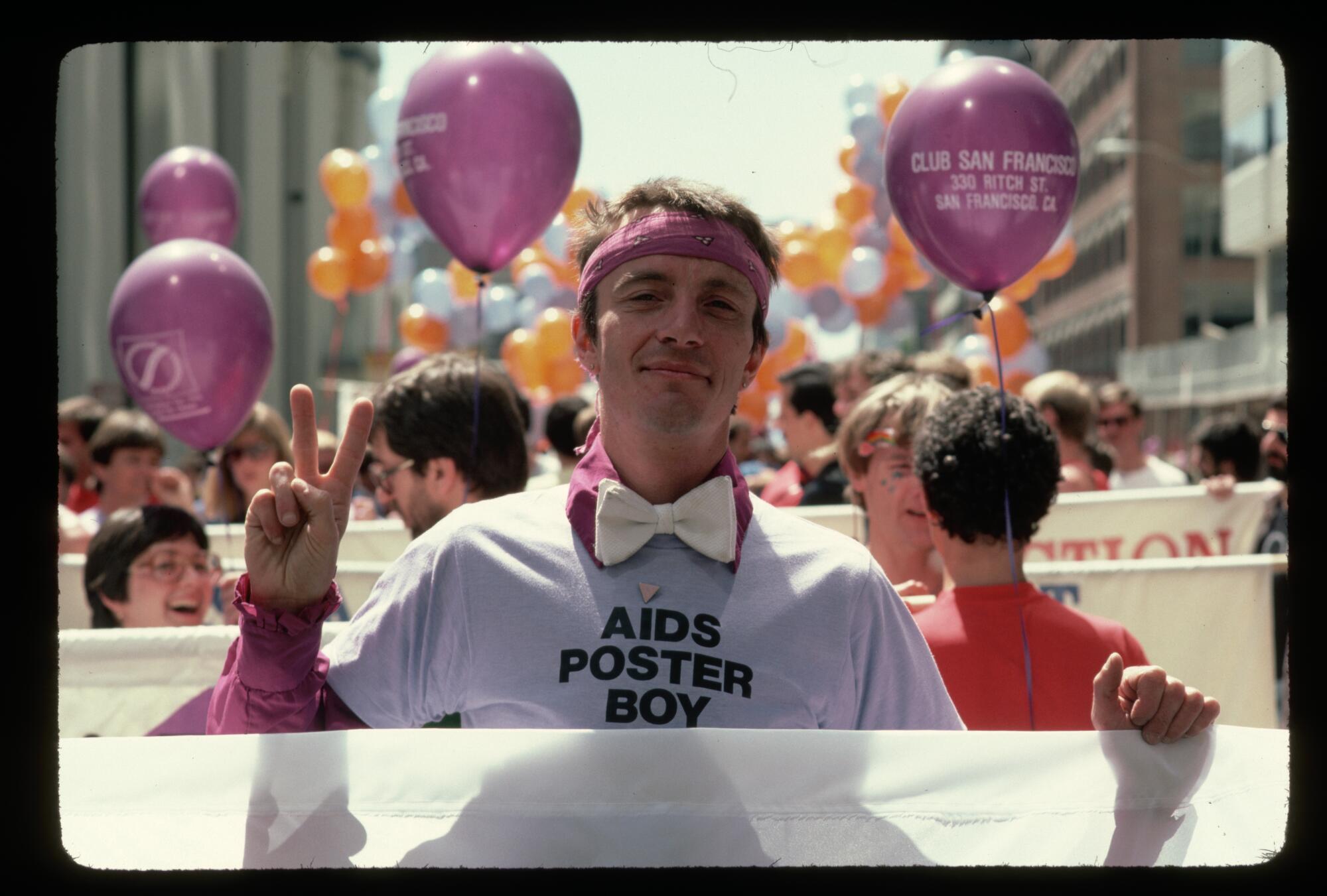 Bobbi Campbell, a man with AIDS, wears a shirt reading "AIDS Poster Boy." 