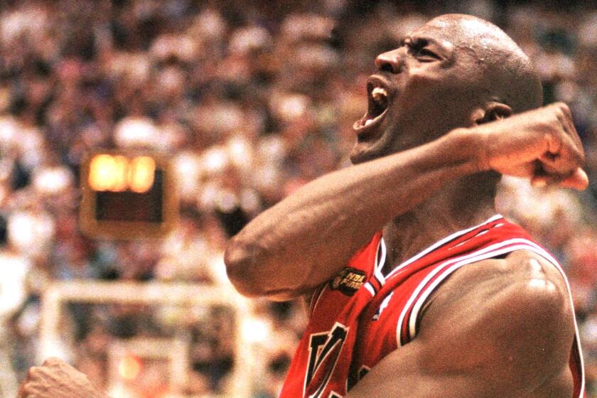 SALT LAKE CITY, UNITED STATES: Michael Jordan of the Chicago Bulls celebrates 14 June after winning game six of the NBA Finals against the Utah Jazz at the Delta Center in Salt Lake City, UT. The Bulls won the game 87-86 to win their sixth NBA Championship. AFP PHOTO/Robert SULLIVAN (Photo credit should read ROBERT SULLIVAN/AFP via Getty Images)