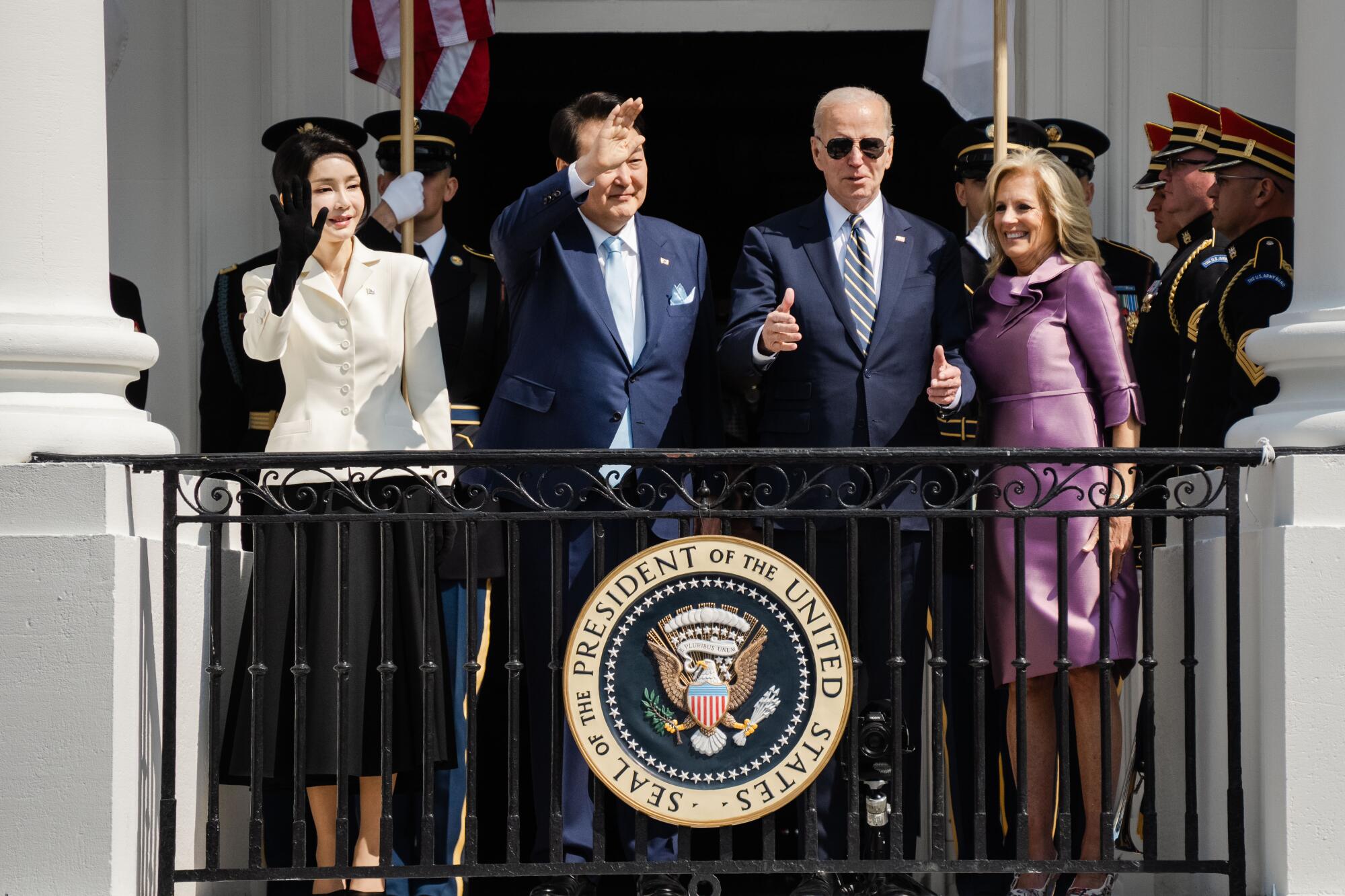 South Korean President Yoon Suk Yeol, President Joe Biden wave from a balcony of the White House.