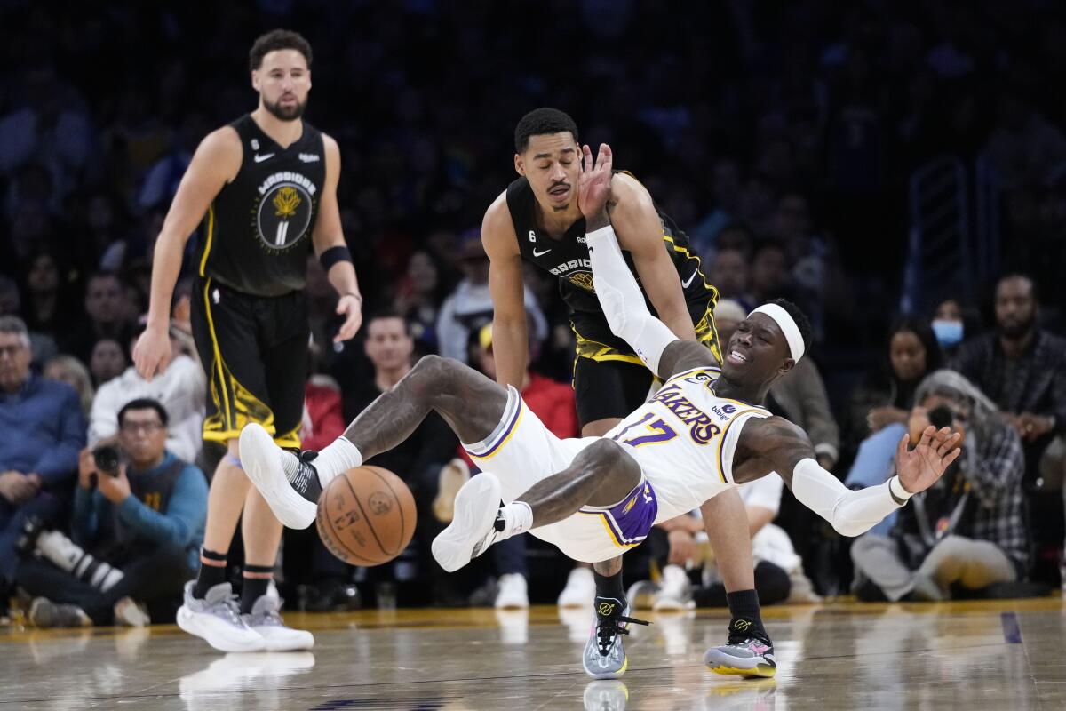 Lakers guard Dennis Schroder is fouled by Golden State Warriors guard Jordan Poole during the second half Sunday.