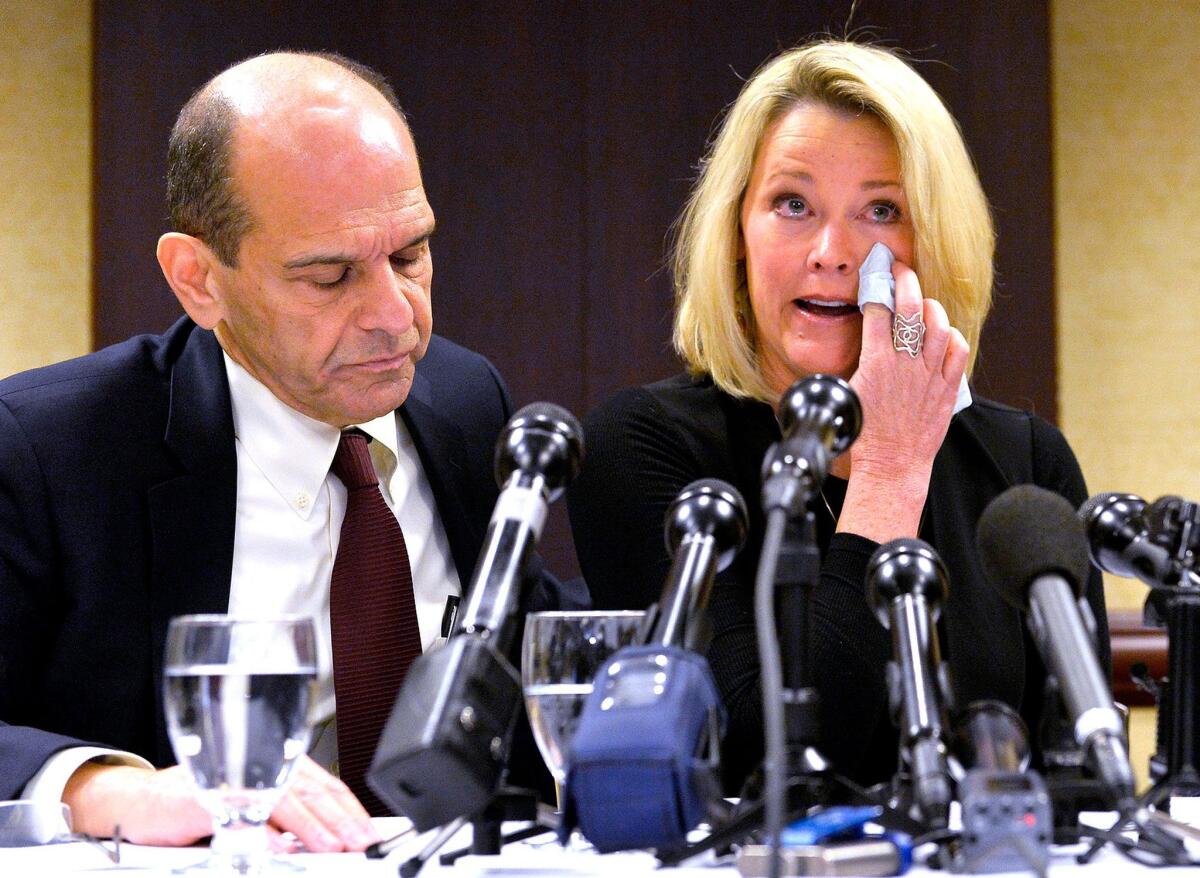 Former Boston news anchor Heather Unruh sits with attorney Mitchell Garabedian at a press conference in Boston on Wednesday.