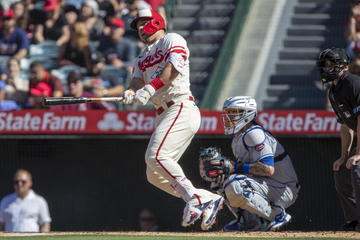 Angels designated hitter Mike Trout hits a run-scoring single during the first inning.