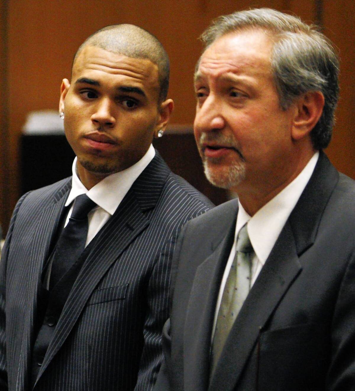 Chris Brown, left, is shown with his attorney, Mark Geragos. The singer is required to perform 180 days of community labor in connection with a 2009 attack on then-girlfriend Rihanna.