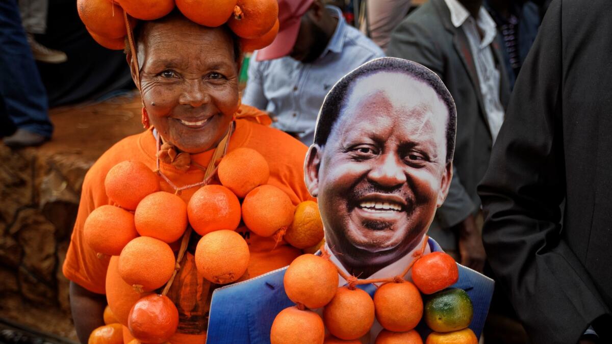 A supporter of opposition presidential candidate Raila Odinga flaunts oranges, the party's symbol, at his final campaign rally in Nairobi on Saturday.