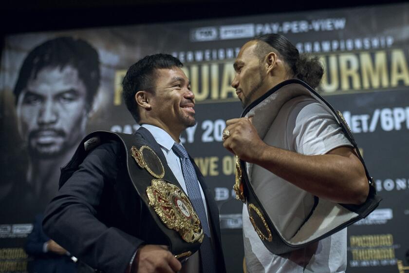 Manny Pacquiao, left, and Keith Thurman stand face to face during a news conference on Tuesday, May 21, 2019, in New York. The two are scheduled to fight in a welterweight world championship boxing bout on Saturday, July 20, in Las Vegas. (AP Photo/Andres Kudacki)