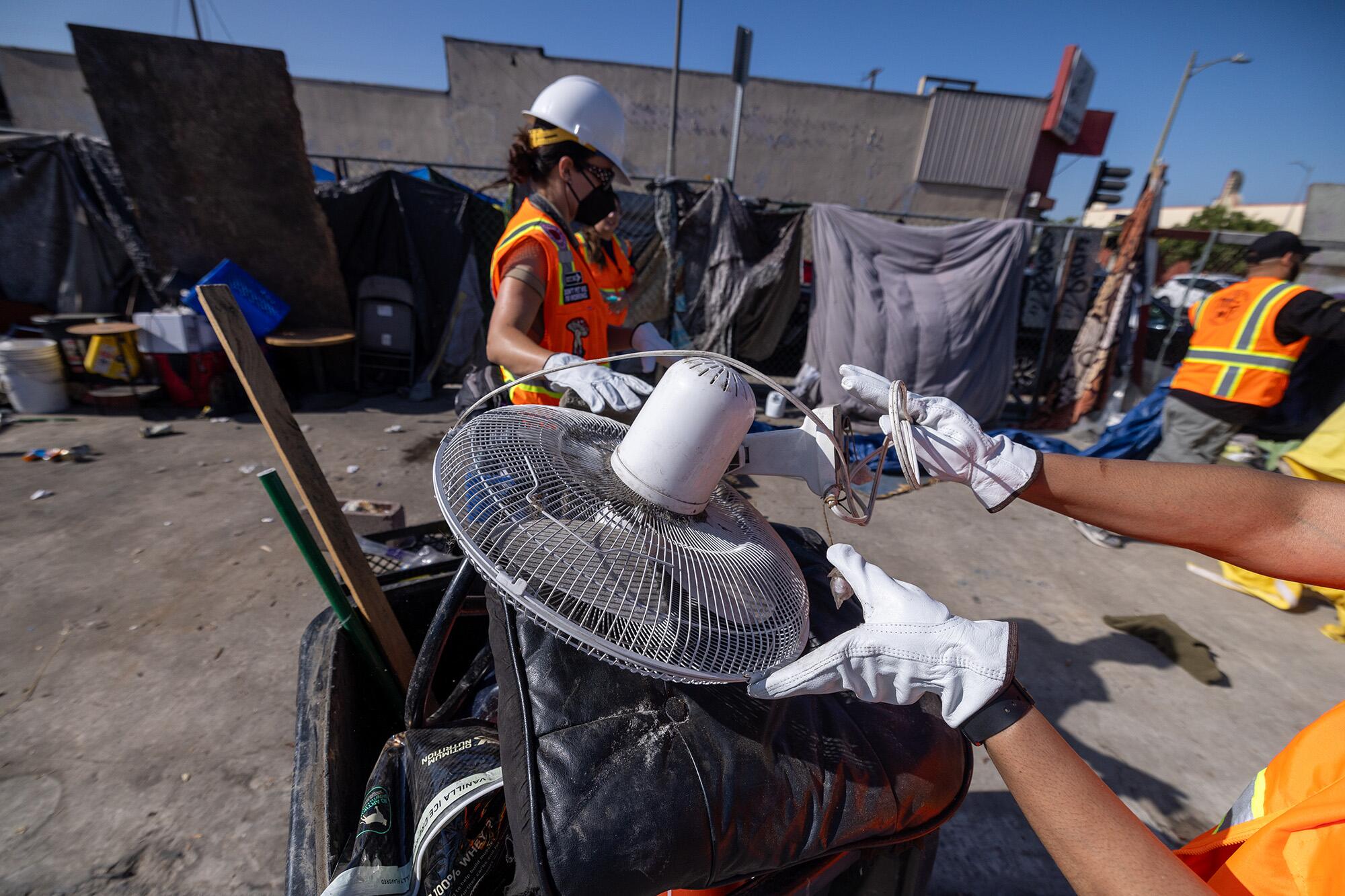 Inside Safe workers clean up a homeless encampment in South Los Angeles.