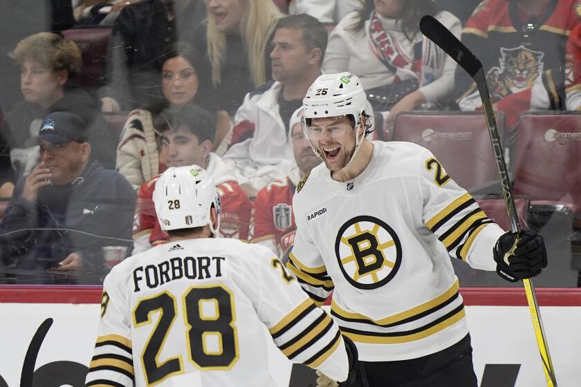 Boston Bruins defenseman Brandon Carlo (25) celebrates his goal with defenseman Derek Forbort (28) during the second period of Game 1 of the second-round series of the Stanley Cup Playoffs against the Florida Panthers, Monday, May 6, 2024, in Sunrise, Fla. (AP Photo/Wilfredo Lee)