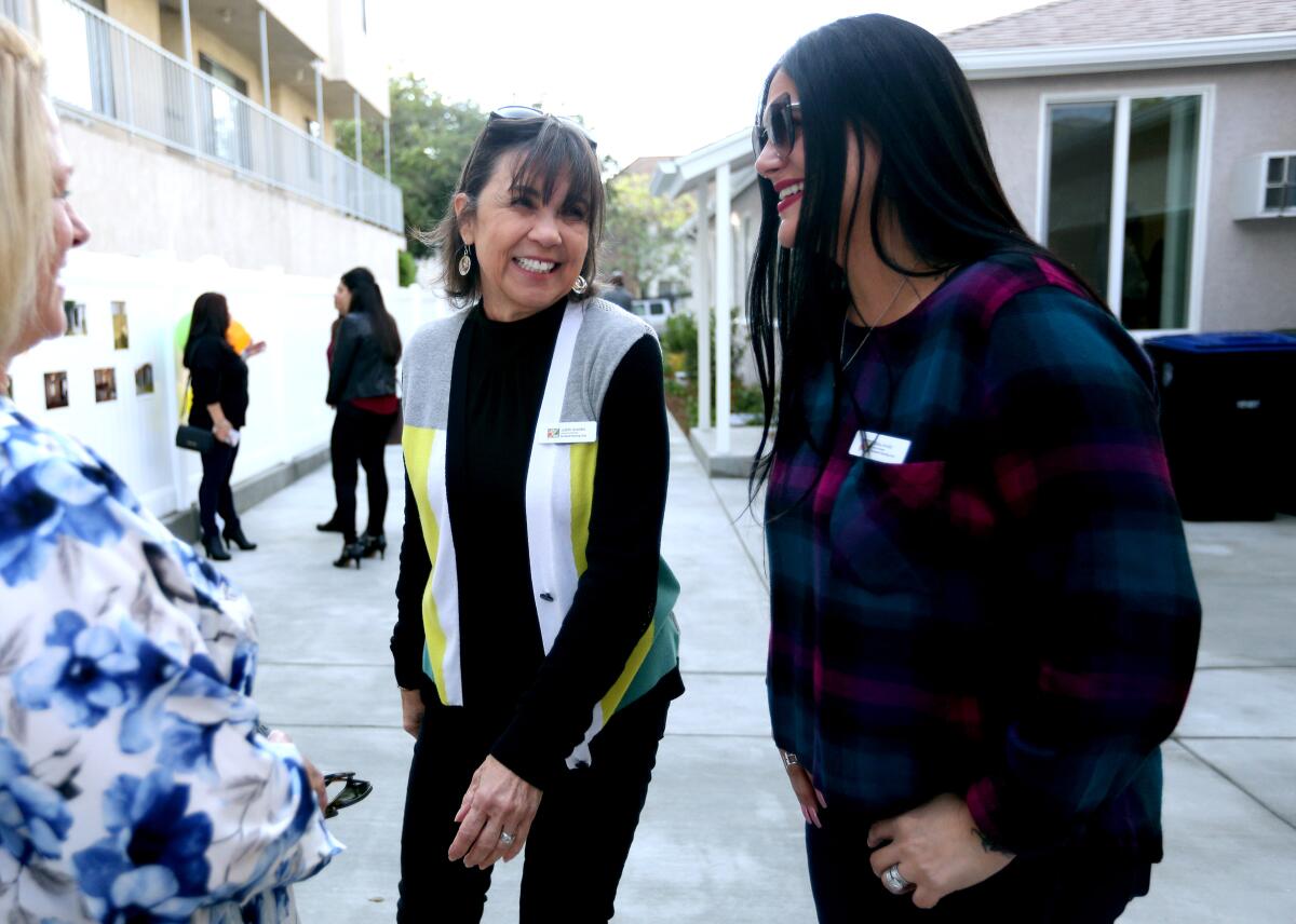 Burbank Housing Corp. Executive Director Judith Arandes, center, and asset manager Raha Arnold have a laugh during the open house to show the newest affordable housing project called the Fairview Cottages, on the 2300 block of North Fairview St., in Burbank on Thursday, Nov. 21, 2019.