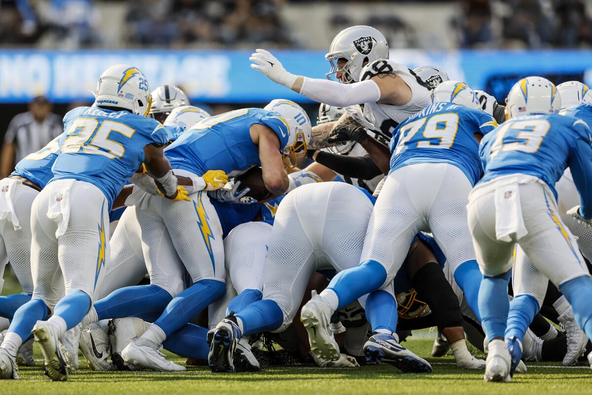 Chargers quarterback Justin Herbert (10) is stopped for no gain on a fourth-and-inches play against the Raiders. 