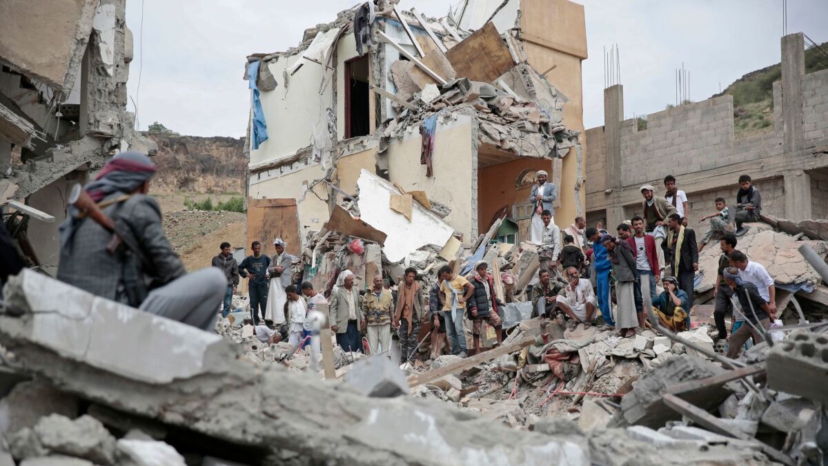 People inspect the rubble of houses destroyed by Saudi-led airstrikes in Sana, Yemen, on Aug. 25, 2017.
