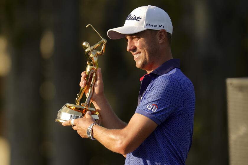 Justin Thomas holds the trophy after winning The Players Championship golf tournament Sunday, March 14, 2021, in Ponte Vedra Beach, Fla. (AP Photo/Gerald Herbert)