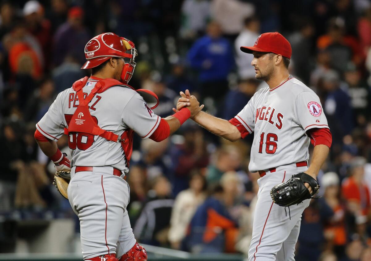 Angels closer pitcher Huston Street celebrates with catcher Carlos Perez (58) after defeating the Detroit Tigers, 8-7.