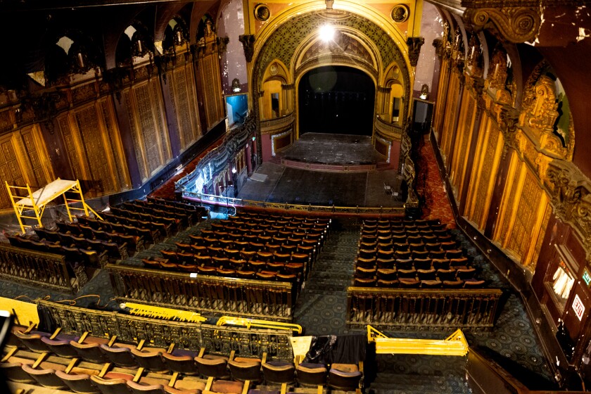 Old movie theater seats, stage and screen in 2018.