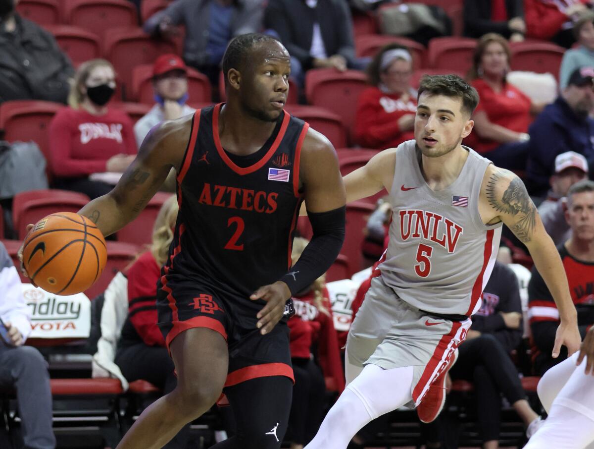 SDSU's Adam Seiko drives against UNLV's Jordan McCabe during their Jan. 1 game in Las Vegas.