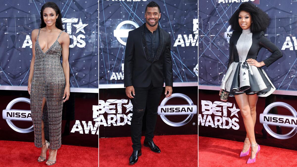 Ciara, left, Russell Wilson and Brandy Norwood arrive at the BET Awards at the Microsoft Theater.