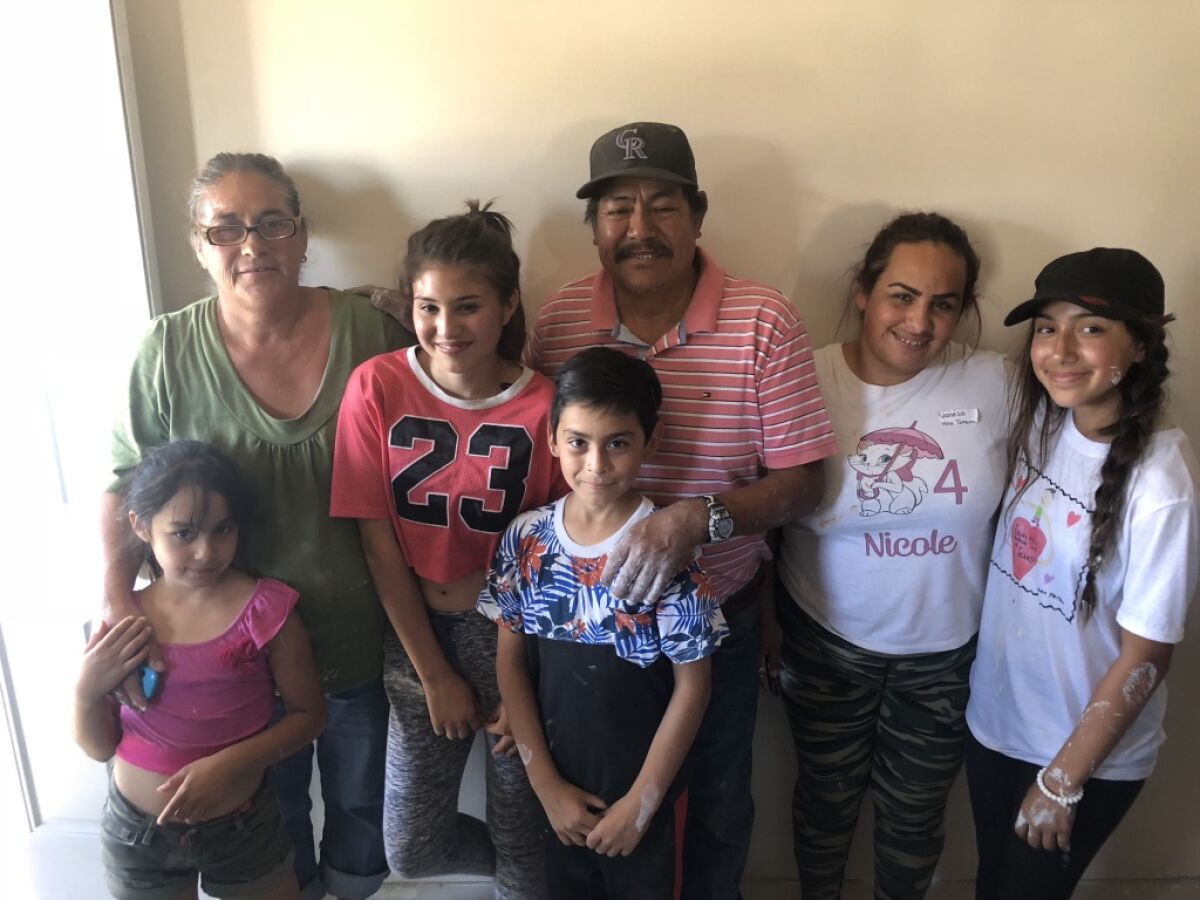 Daniella Benitez (right) pictured with a family that she helped previously through Build A Miracle.