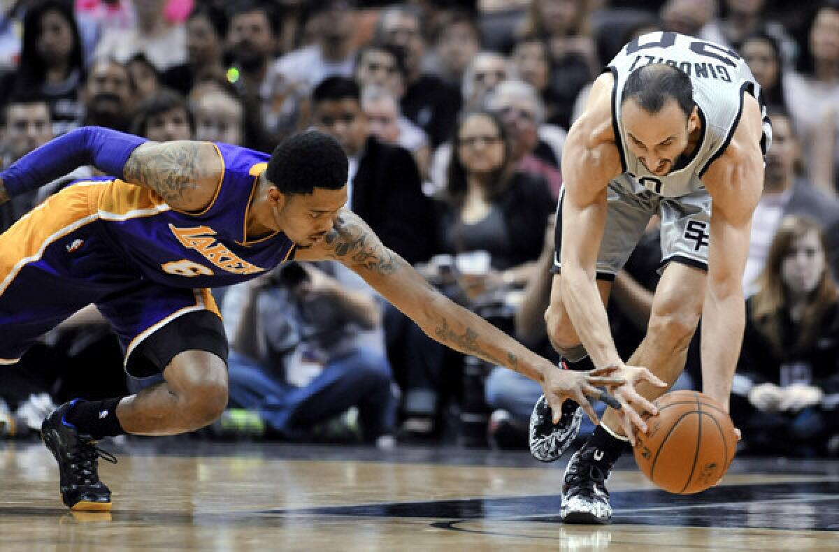 Spurs guard Manu Ginobili gets to a loose ball before Lakers guard Kent Bazemore in the first half Friday night in San Antonio.