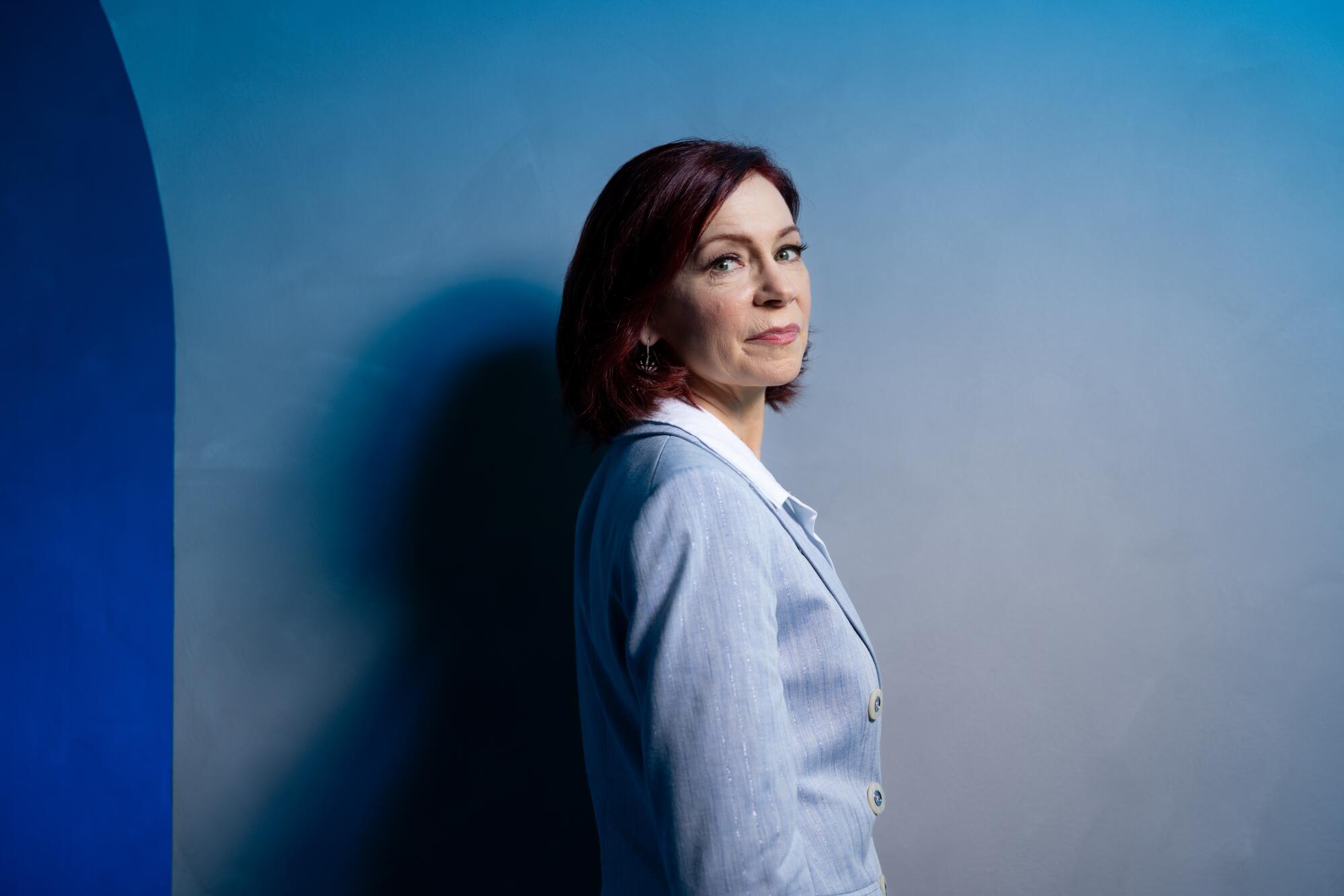 Carrie Preston turns her face toward the camera in a portrait.