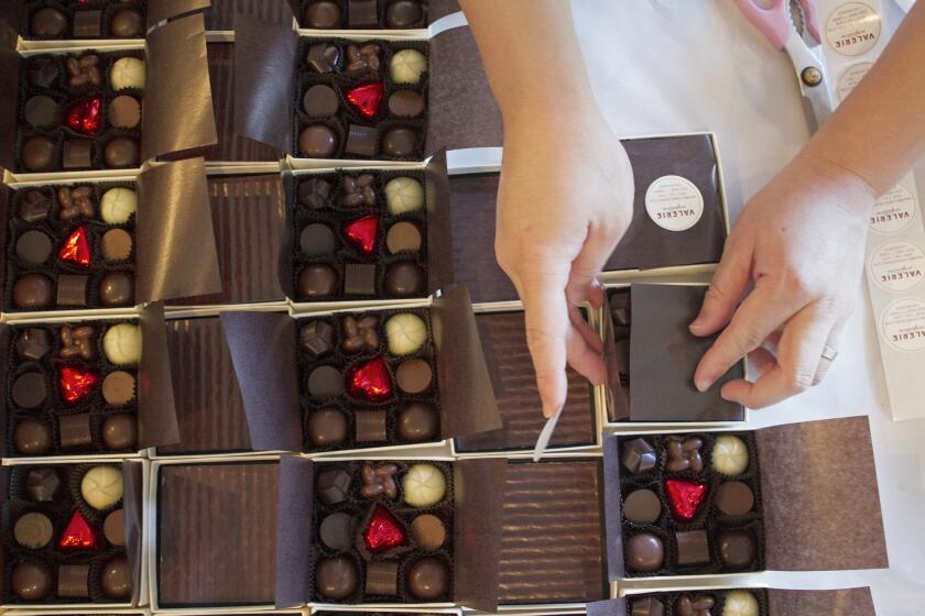 Boxes of truffles being wrapped at Valerie Confections.