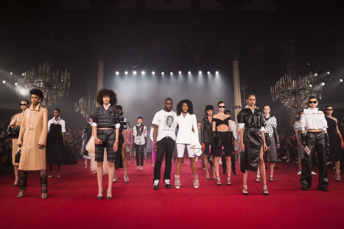 A photo of Off-White founder Virgil Abloh with Naomi Campbell and models.