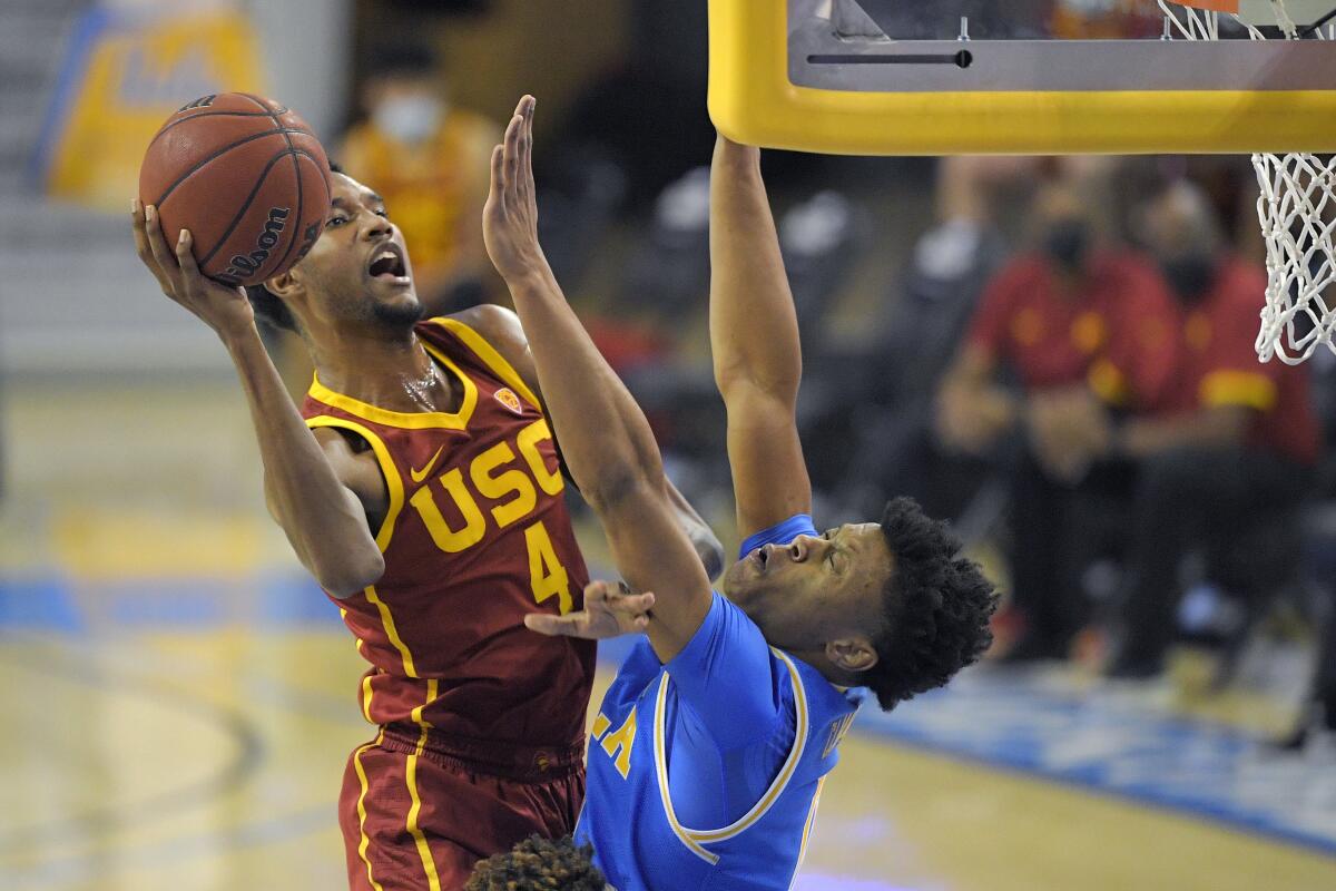 USC forward Evan Mobley shoots as UCLA guard Jaylen Clark defends.