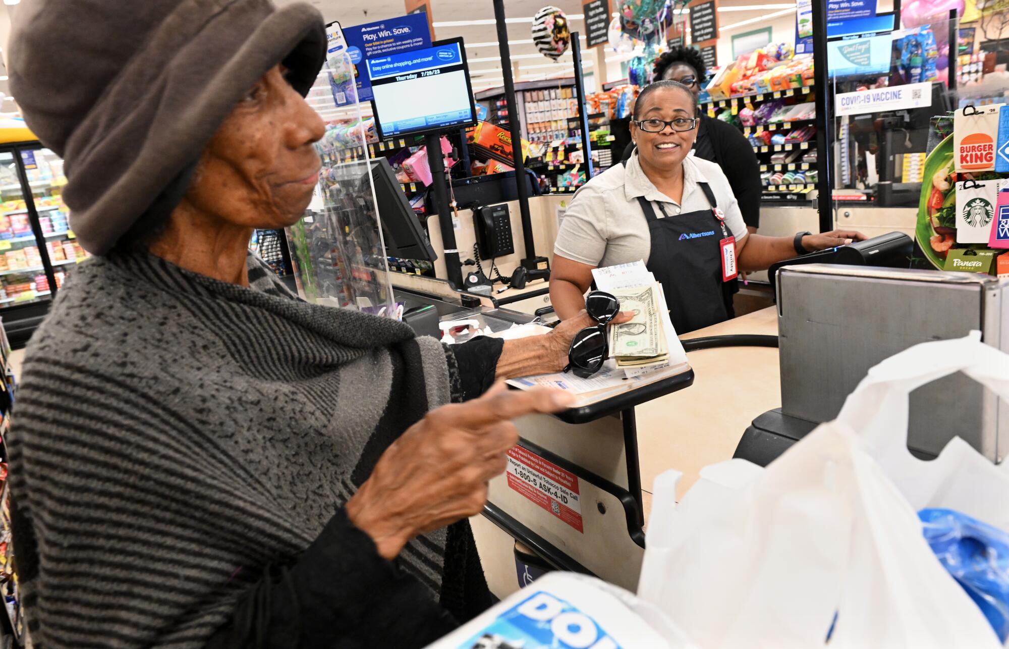 A cashier helps a customer.