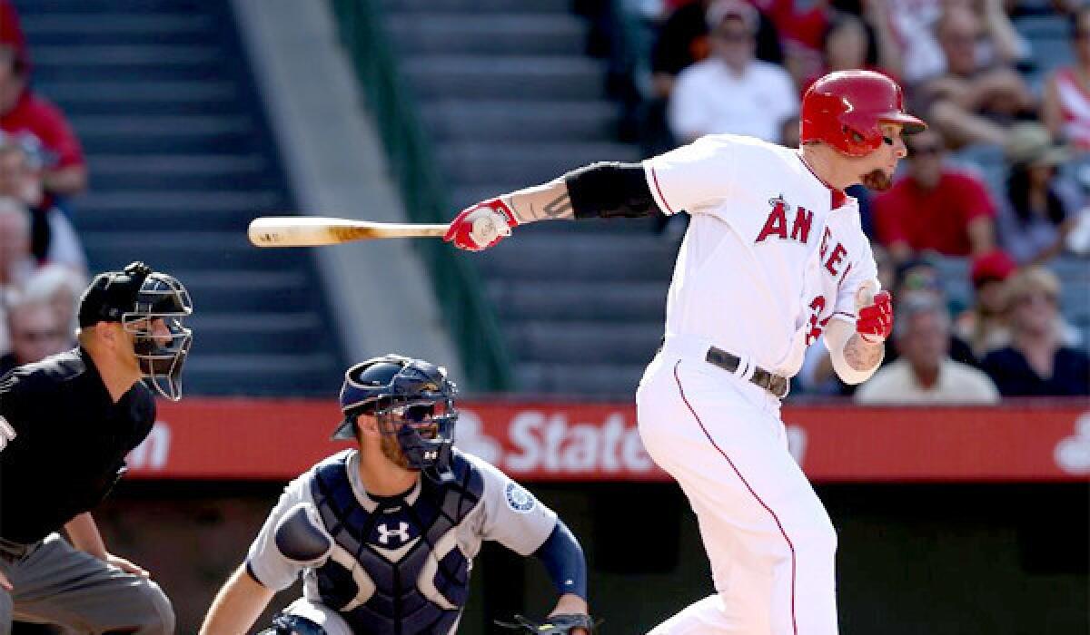 Josh Hamilton hits a single that drives in two runs during the Angels' victory over the Seattle Mariners, 7-1.