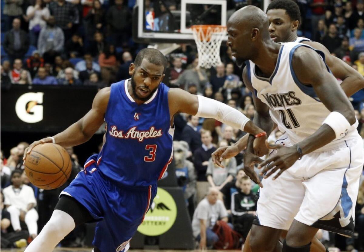 Timberwolves forward Kevin Garnett tries to cut off a drive by Clippers point guard Chris Paul during a game last season.