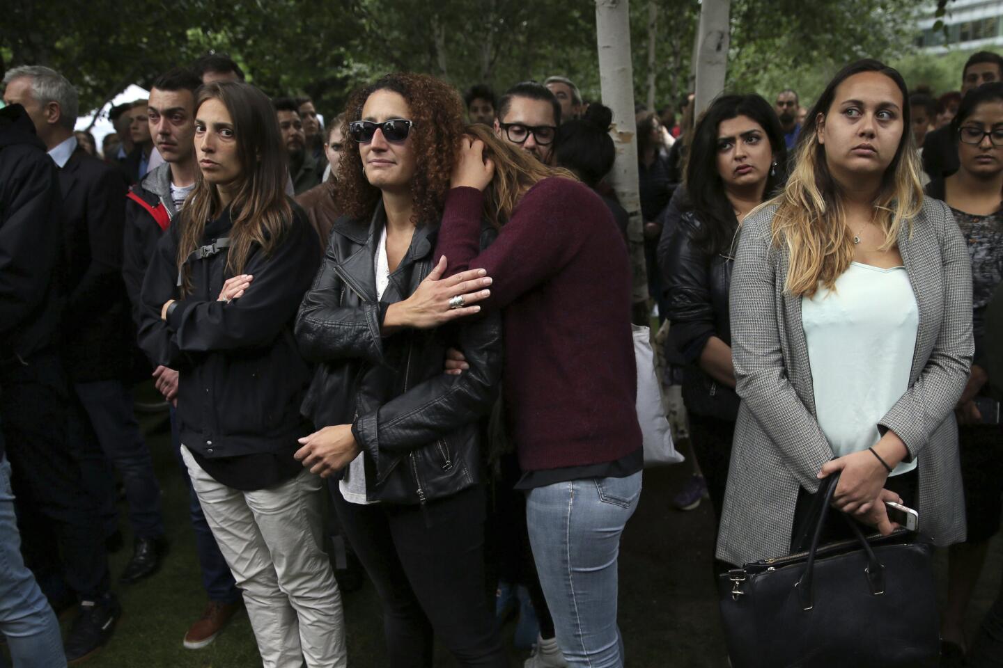 People attend a vigil for victims of Saturday's attack at Potters Fields Park in London on Monday.