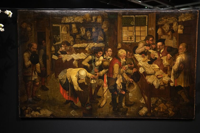 The painting "Payment of the Yearly Dues", also known as "The Peasants' Lawyer" by Pieter Brueghel The Young, estimated to be dating before 1618, is in display at the Drouot auction house in Paris, Monday, March 27, 2023. A rare Brueghel the younger painting found behind a door in French home goes under the hammer in Paris at Drouot Auction house. (AP Photo/Michel Euler)